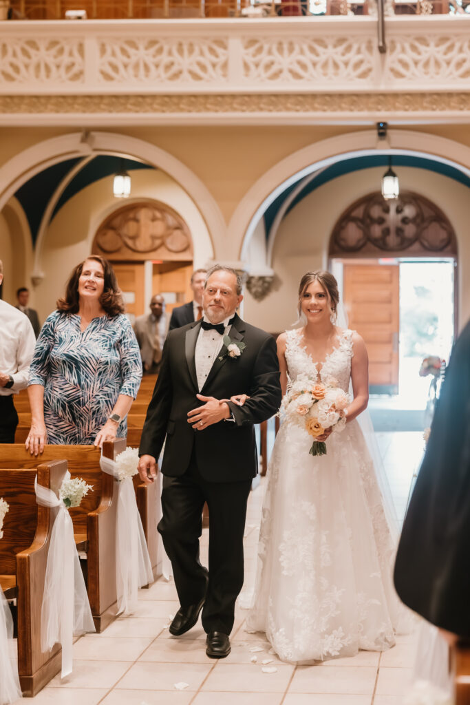 Father and bride walking down aisle 