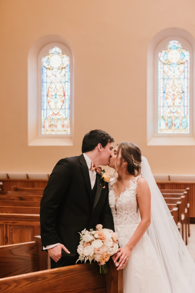 Bride and Groom kissing in Catholic church