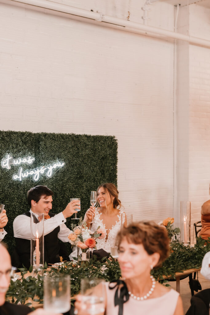 Bride and Groom toasting at reception during wedding speeches, Michigan wedding venue, The Collins Off Main, Chelsea, Ann Arbor