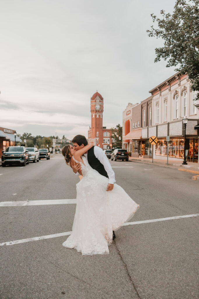 Bride and Groom kissing in the streets of Chelsea, Michigan after wedding