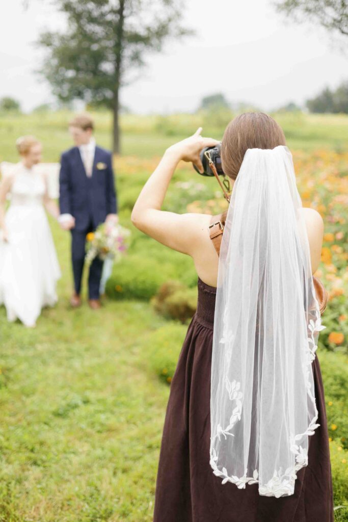 Of the Land Wedding Venue - Wedding Photographer taking Bridal Portraits in Flower Field