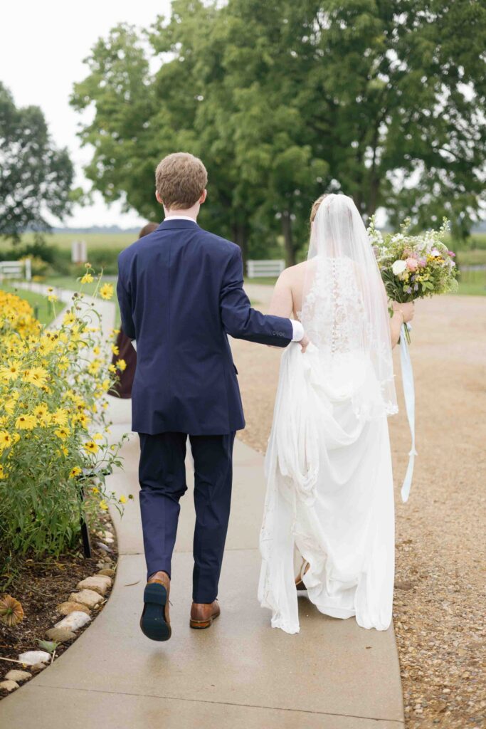 Of the Land Wedding Venue - Couple Walking around wedding venue