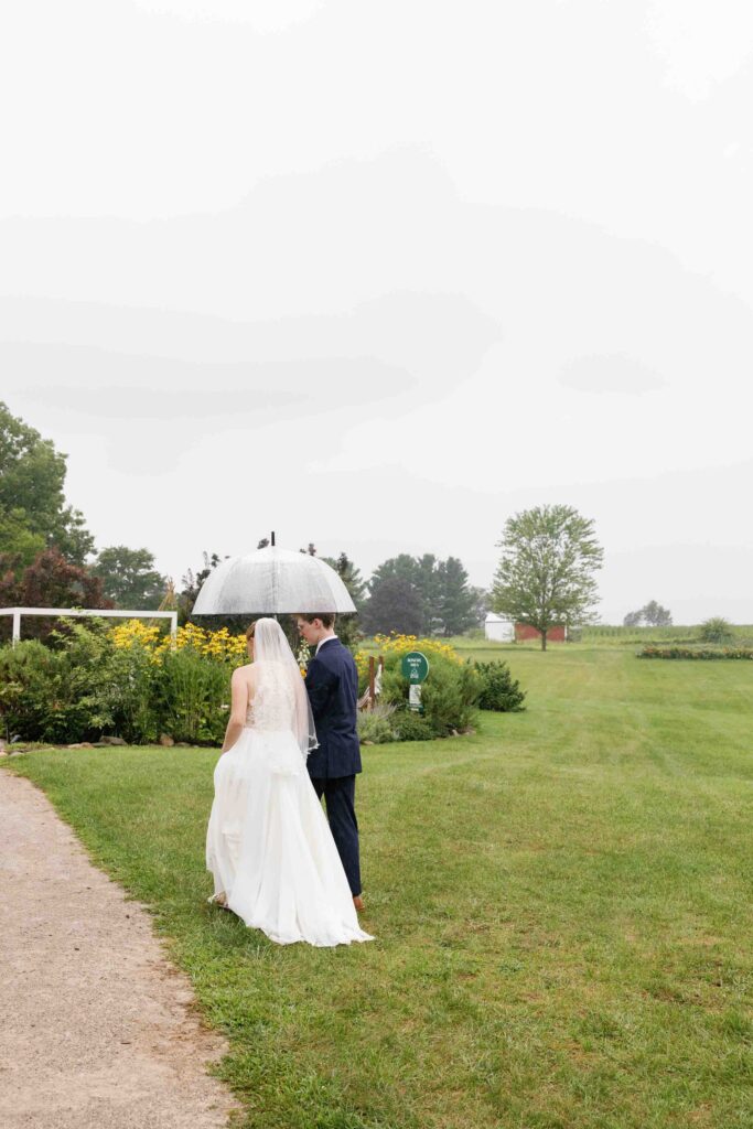 Of the Land Wedding Venue - Couple walking in the rain